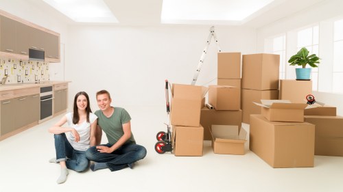 Moving team loading furniture in a residential North Sheen street